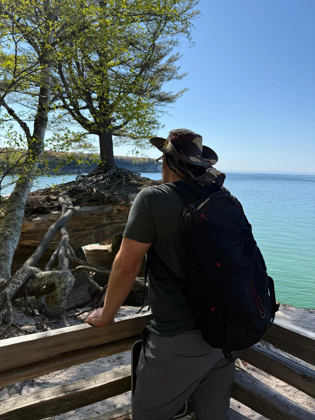 Ackley Will looking across clear water from a wooded overlook